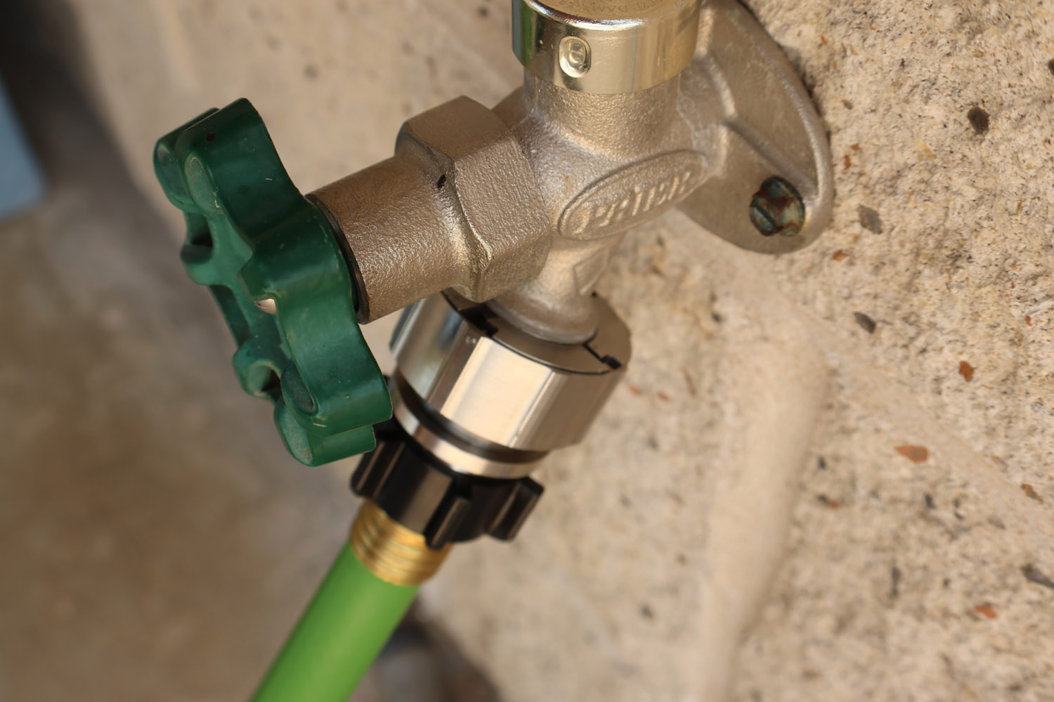 Hose Shark installed on brick wall faucet