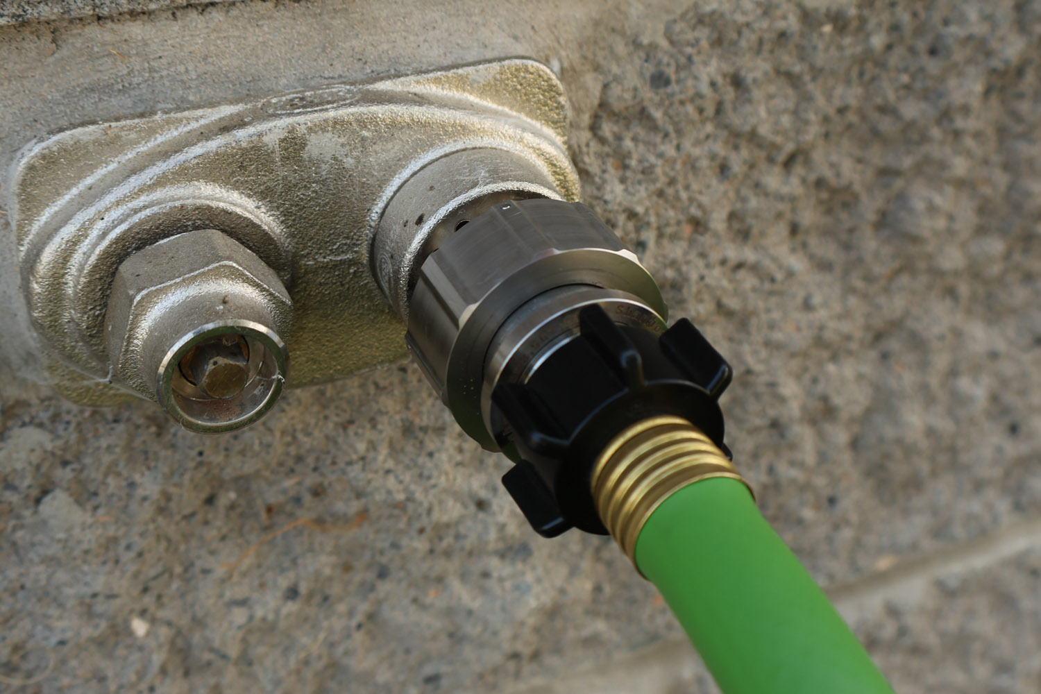 Hose Shark connector attached to landscaping crew hose